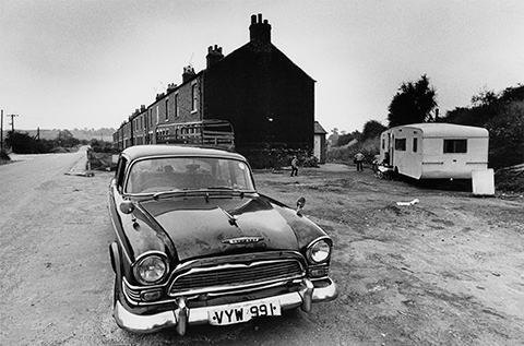 Vintage black and white print scan 1972 image of old Humber car and trailer outside condemned terrace of houses gypsy encampment at Anston near Sheffield